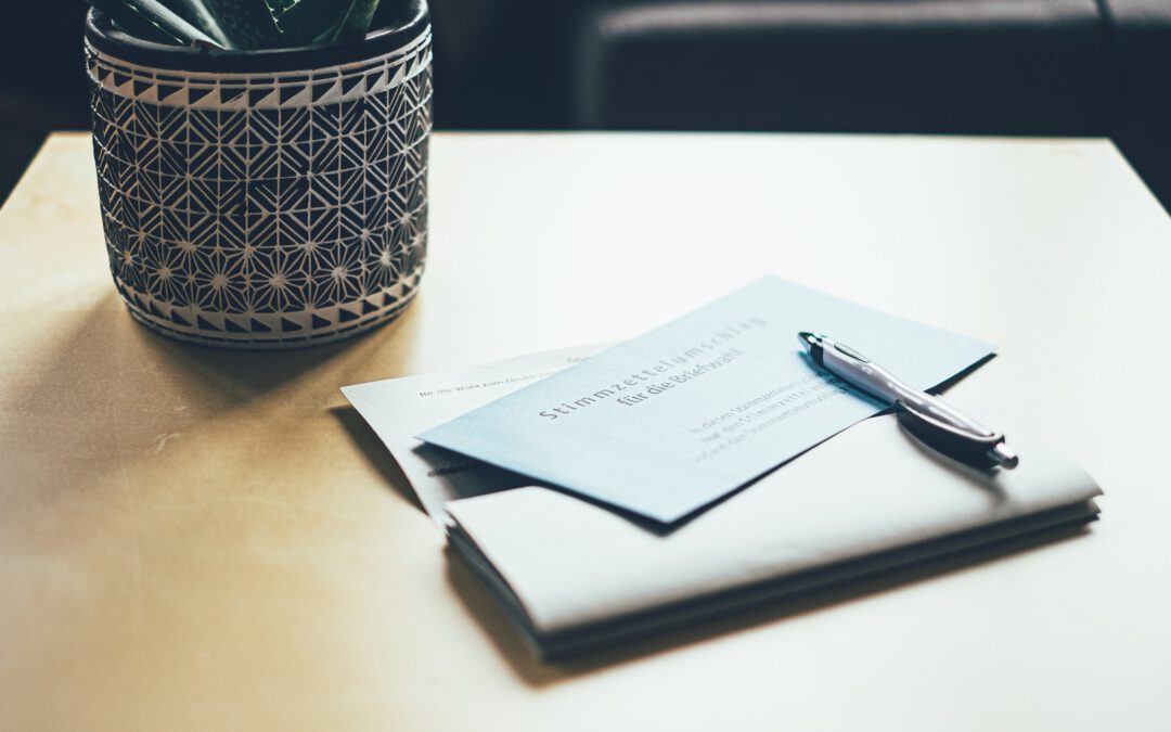 black and white book page beside black framed eyeglasses